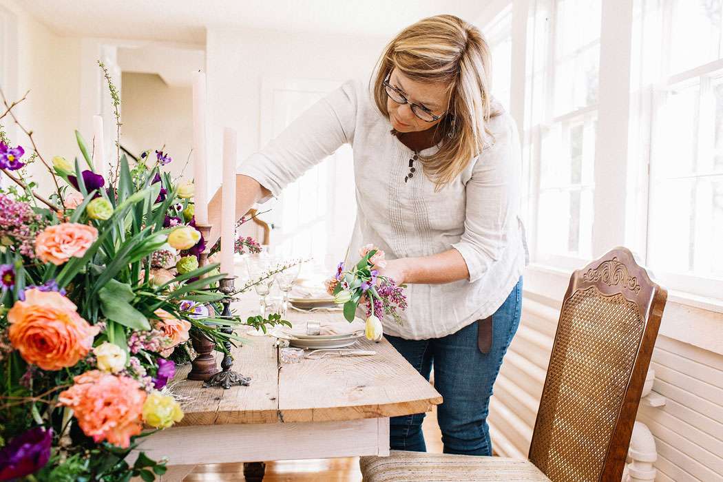 Holly Heider arranging floral centerpiece