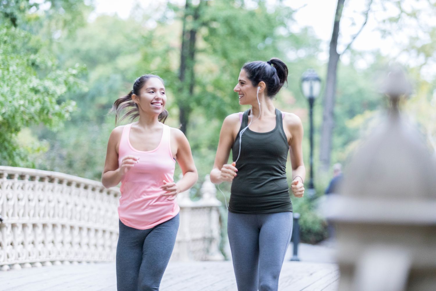 Two women walking in a park to exercise.