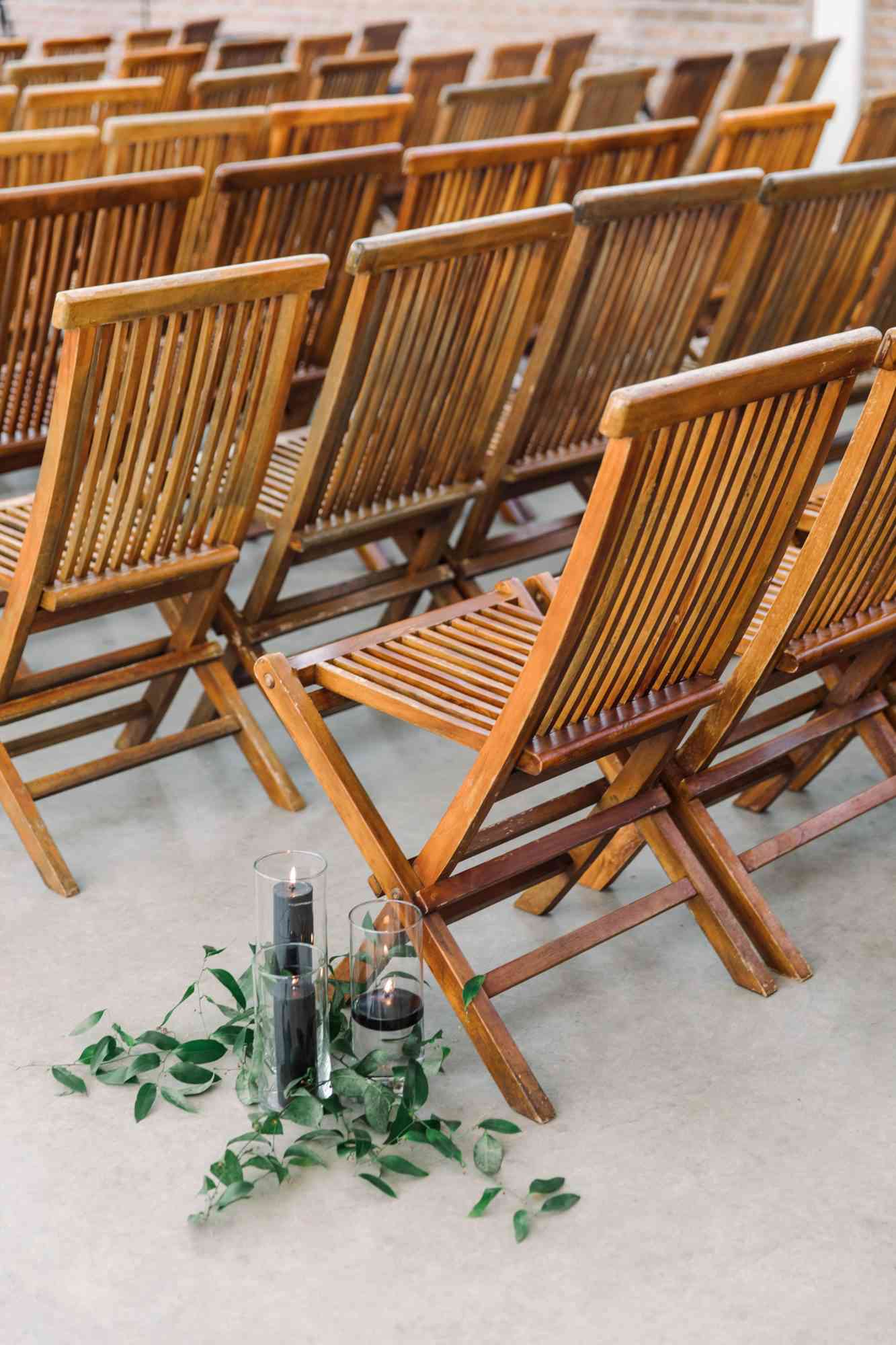 wedding ceremony wooden chairs candles greenery
