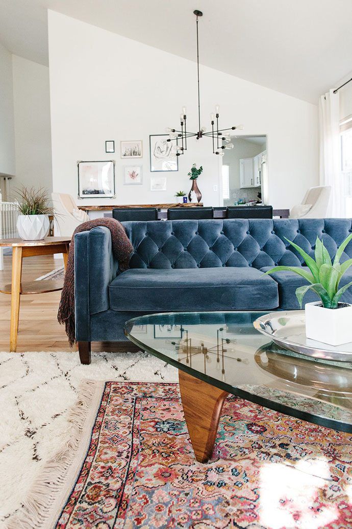 layering rugs and blue couch