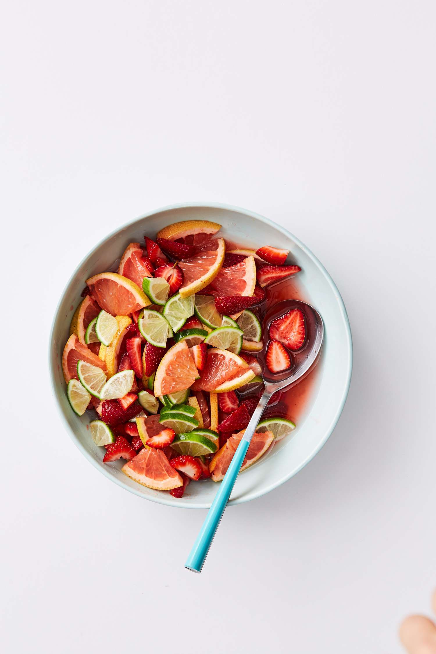 sangria in bowl with strawberries and limes