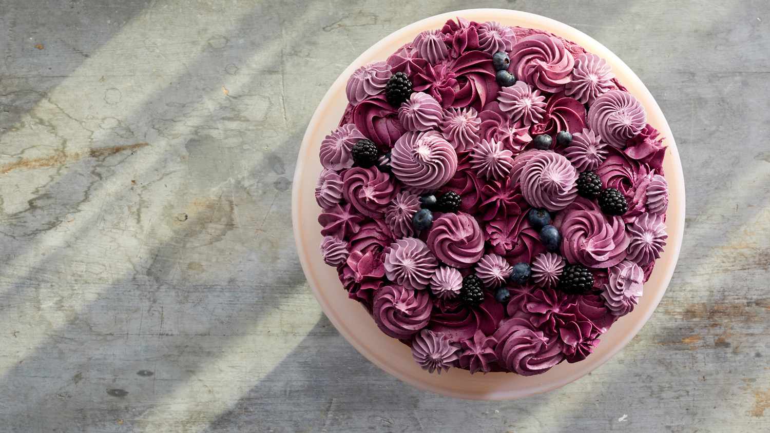 overhead of purple frosted berry layer cake