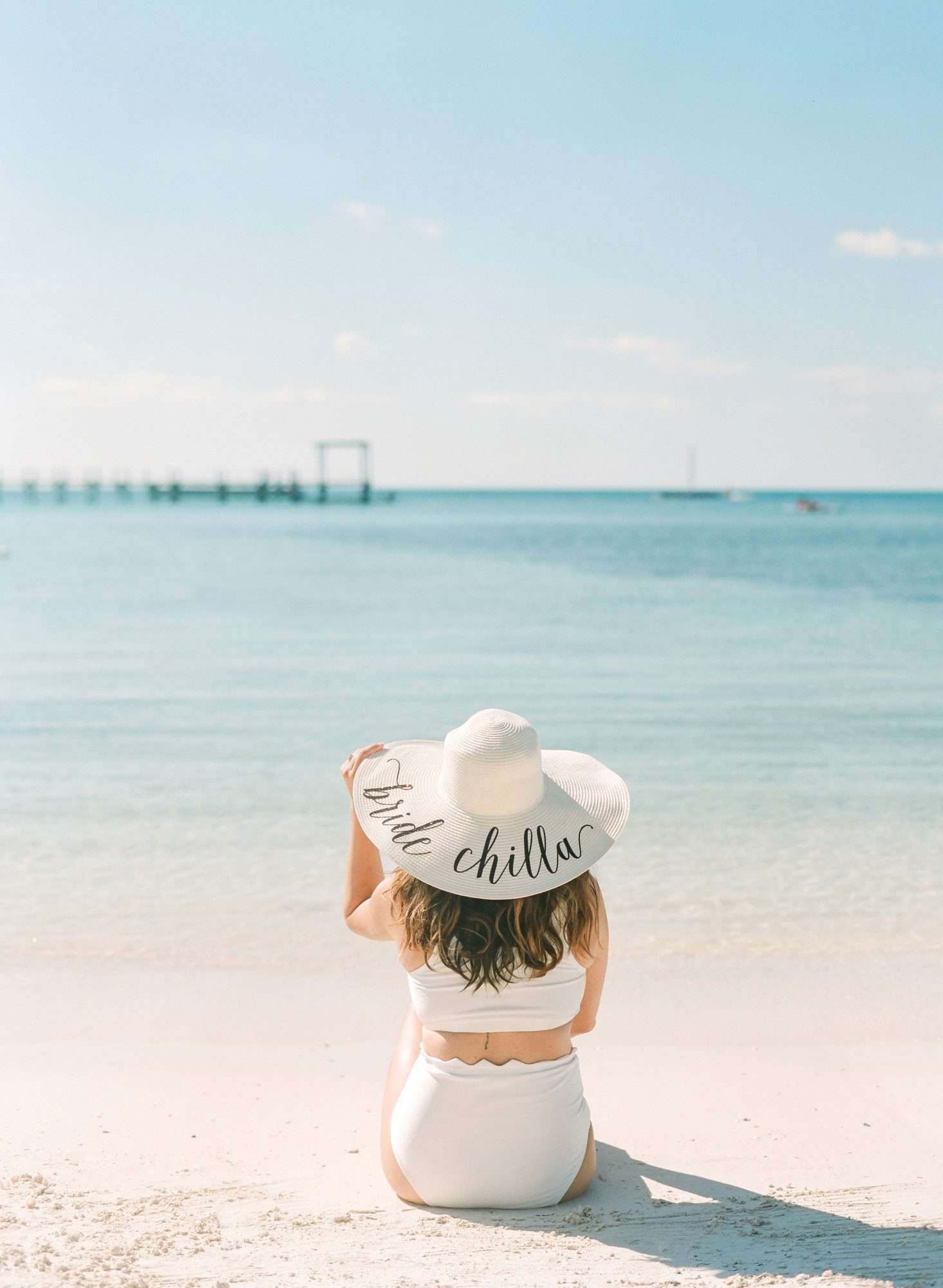 woman wearing bride chilla straw hat on beach