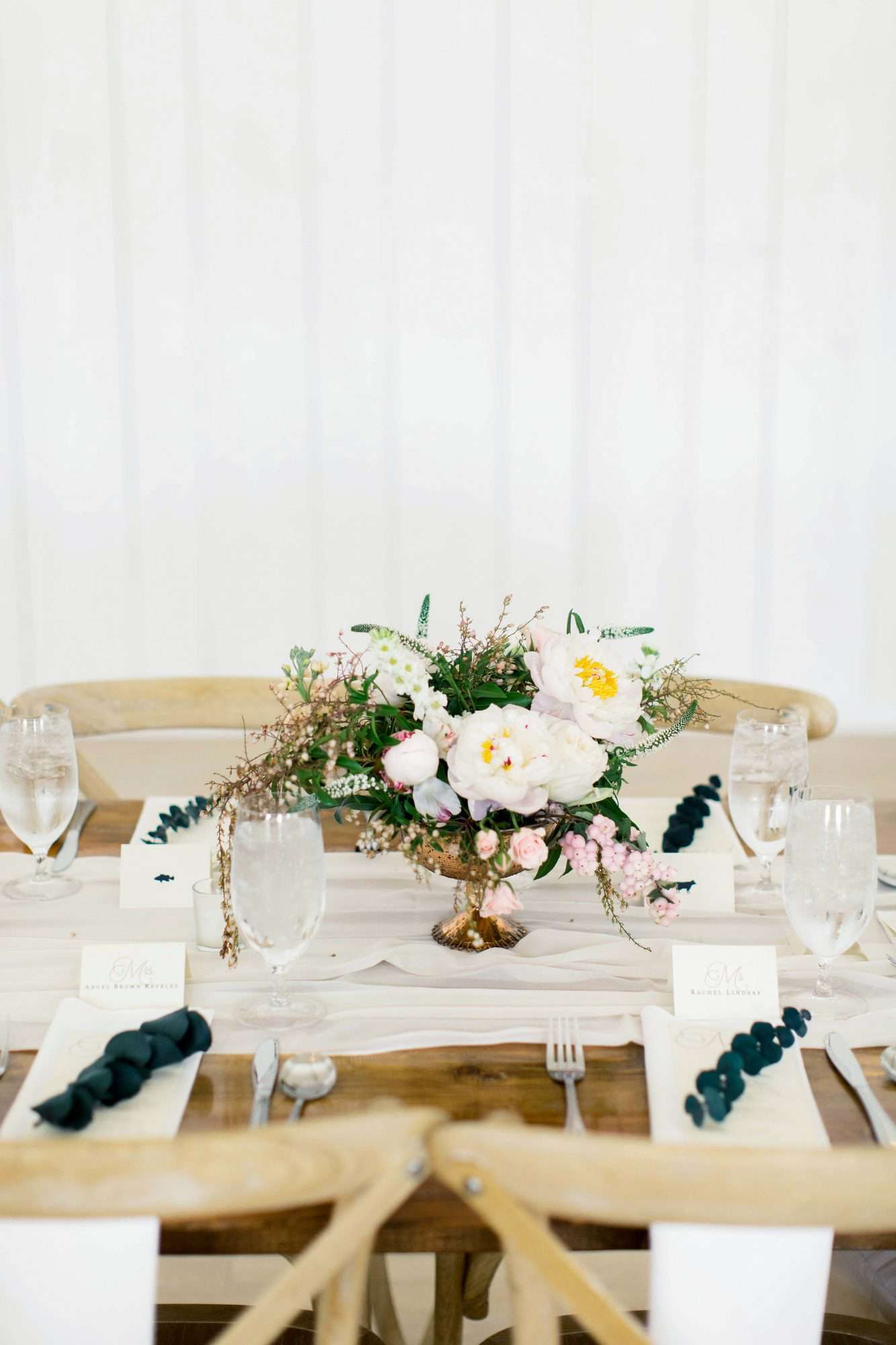 wedding reception table setting with floral centerpiece