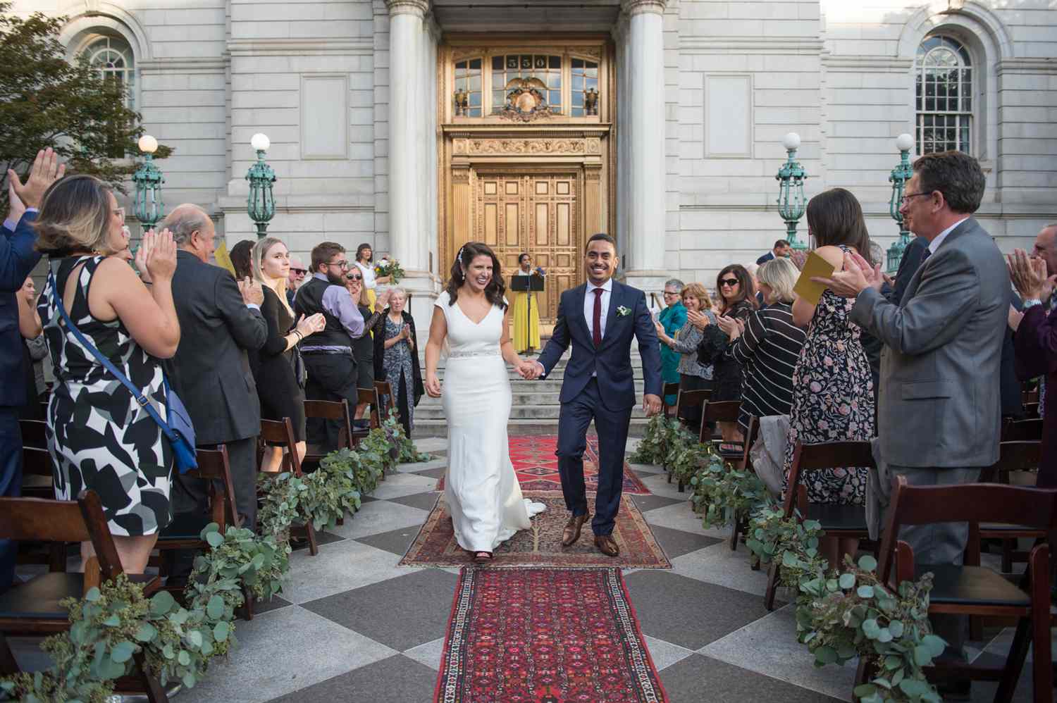city hall wedding recessional bride and groom walking down path of rugs