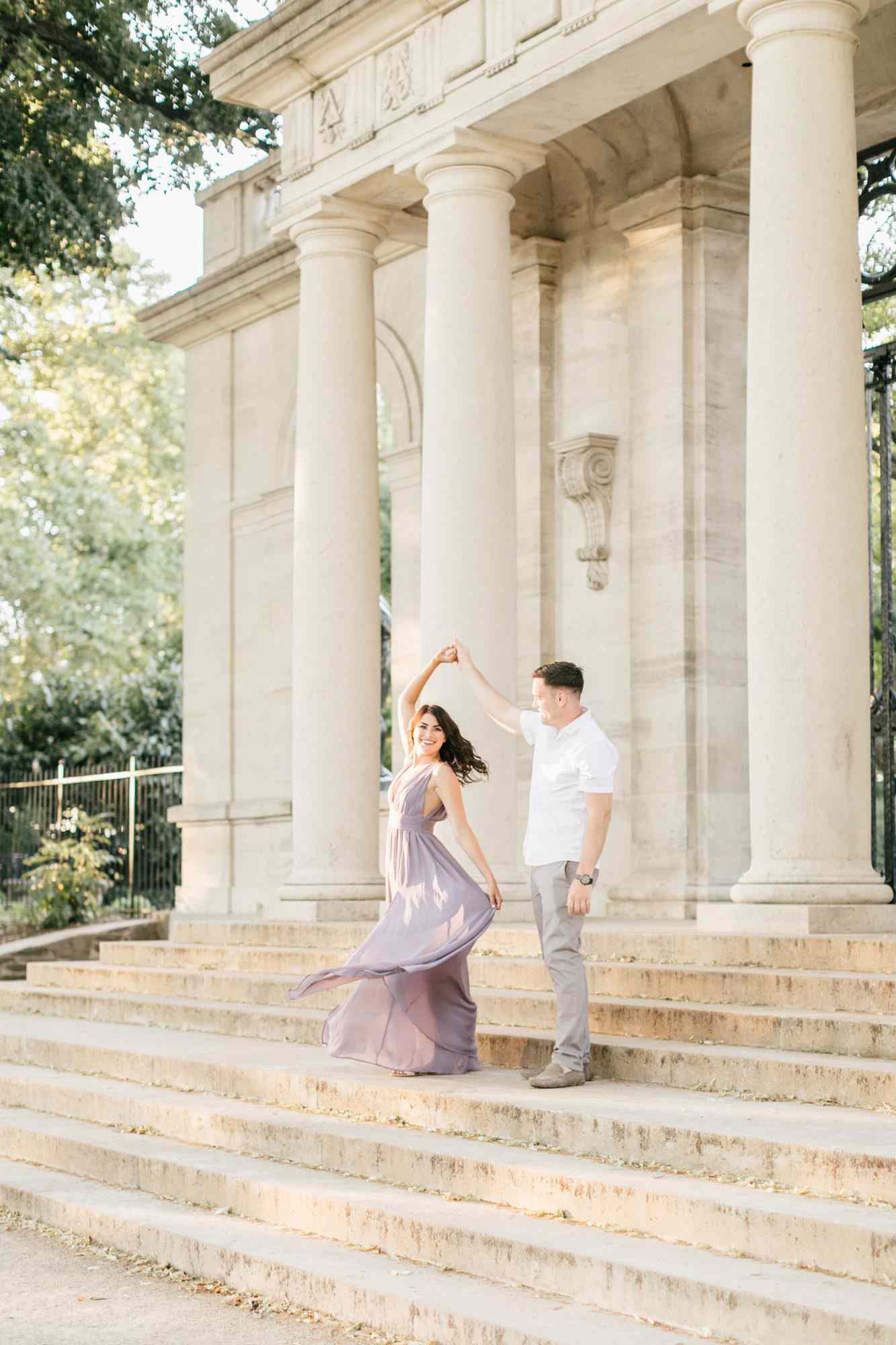couple twirling on front steps engagement photo