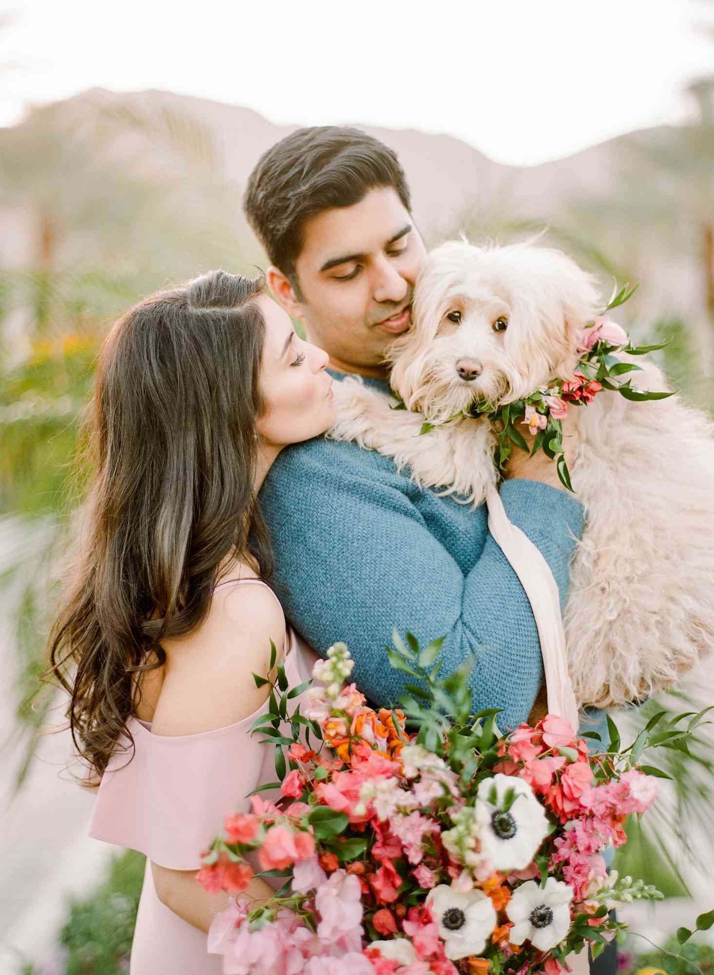 couple with dog and flowers engagement photo