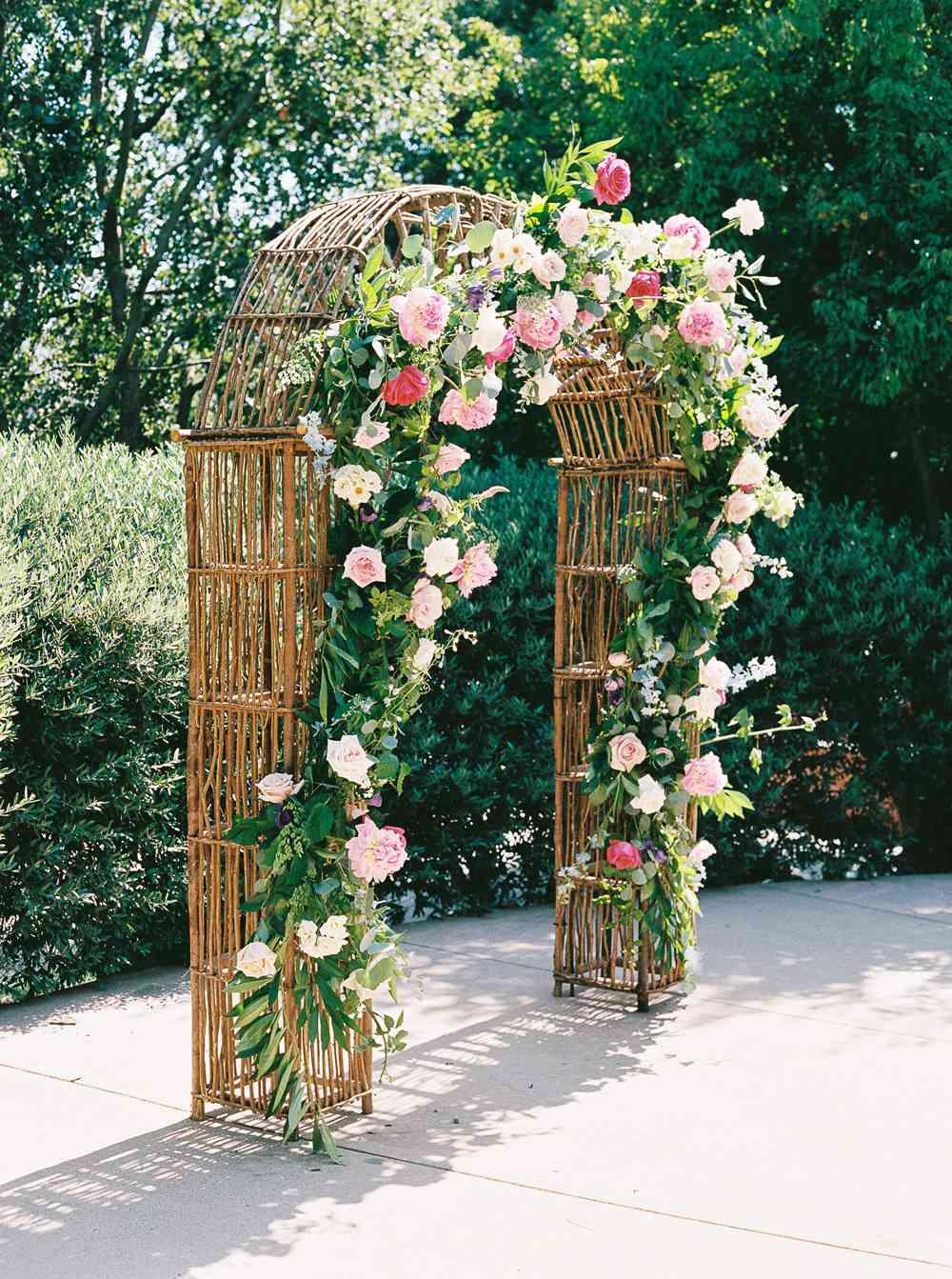 woven rattan wedding decor ceremony arch decorated with roses