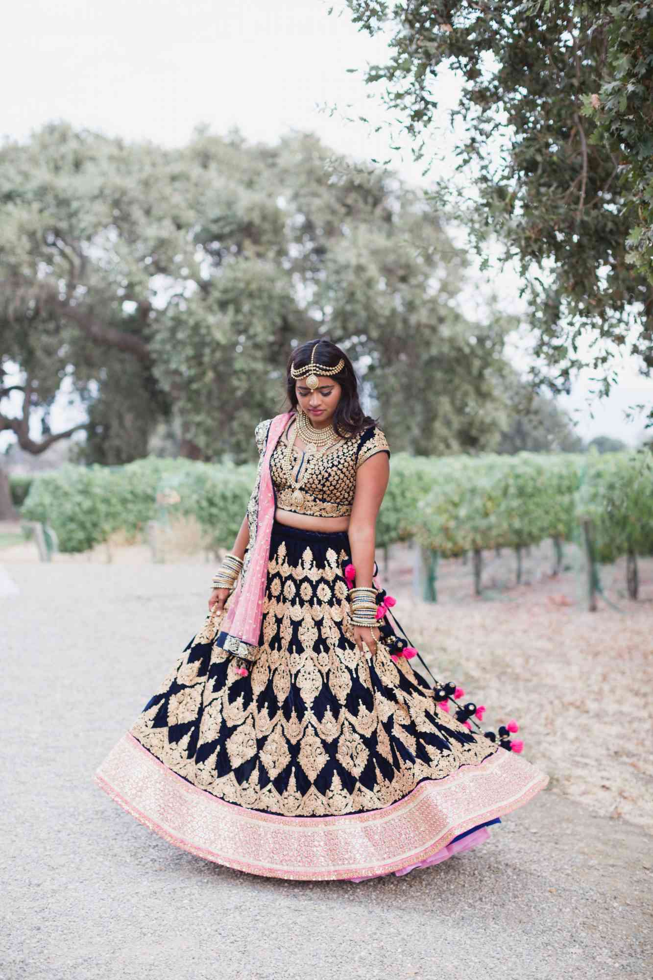 bride in black pink and gold indian lengha