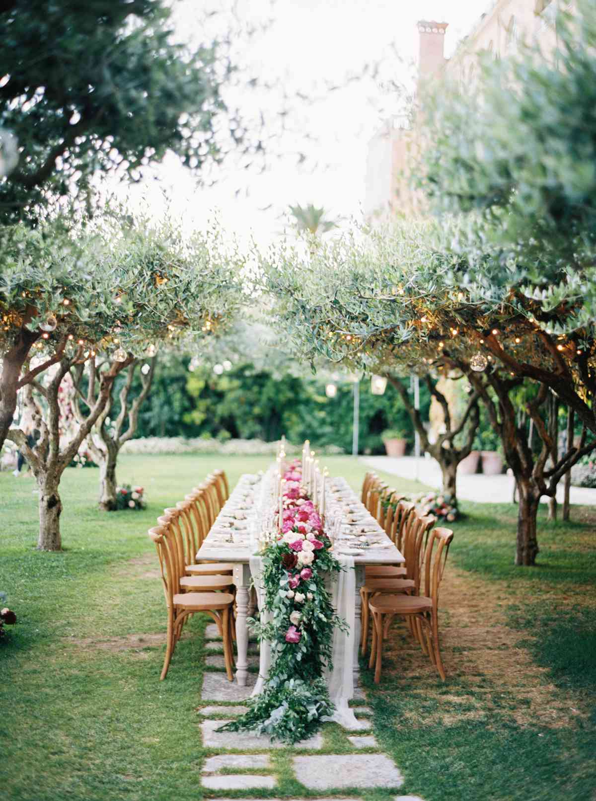 allie and joe italy wedding long reception table beneath olive trees
