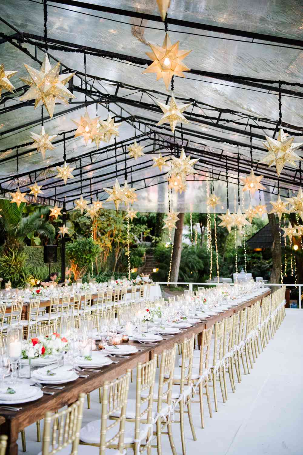 wedding reception tables with star lanterns hanging above