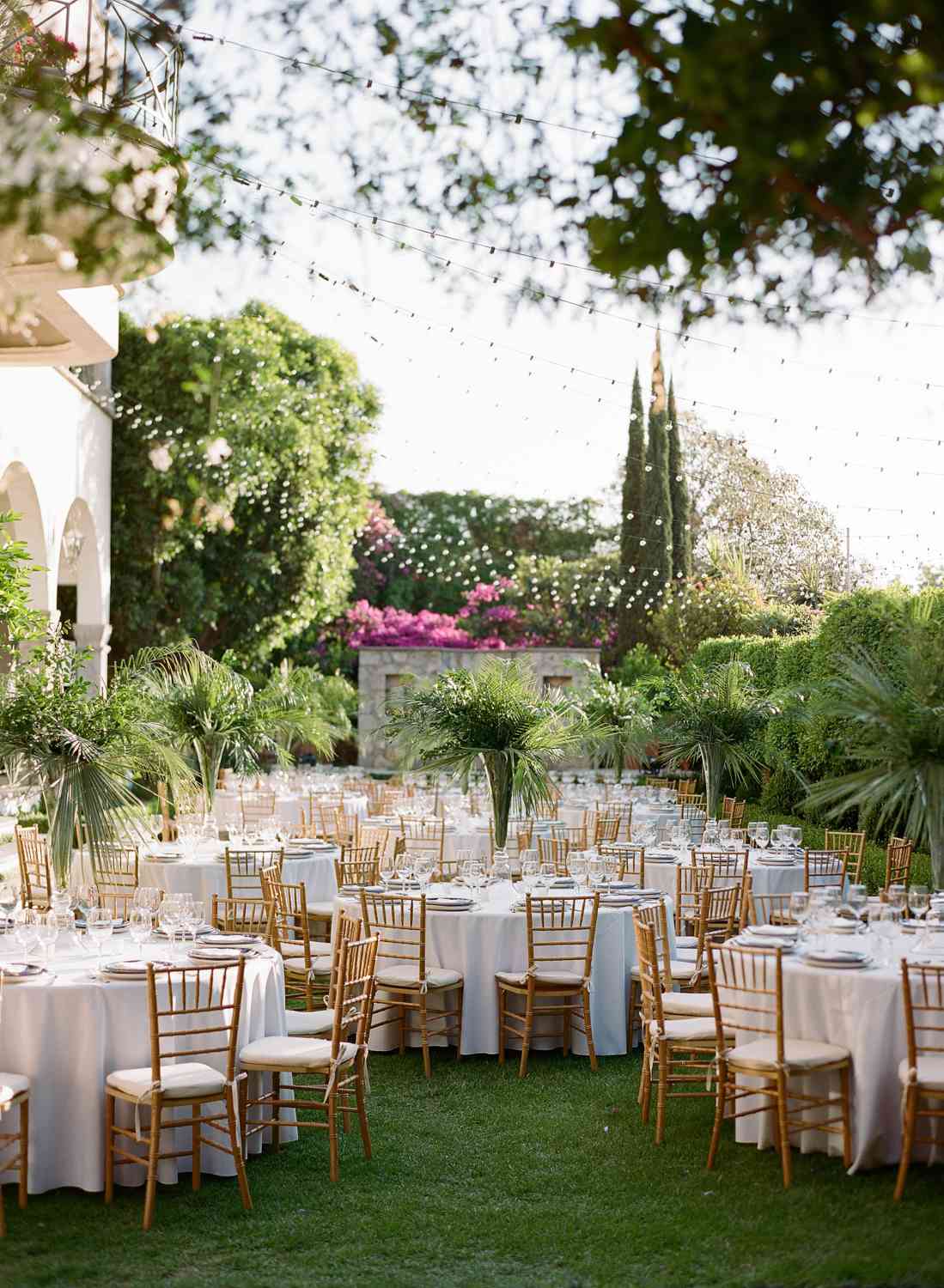 round rehearsal dinner tables in courtyard
