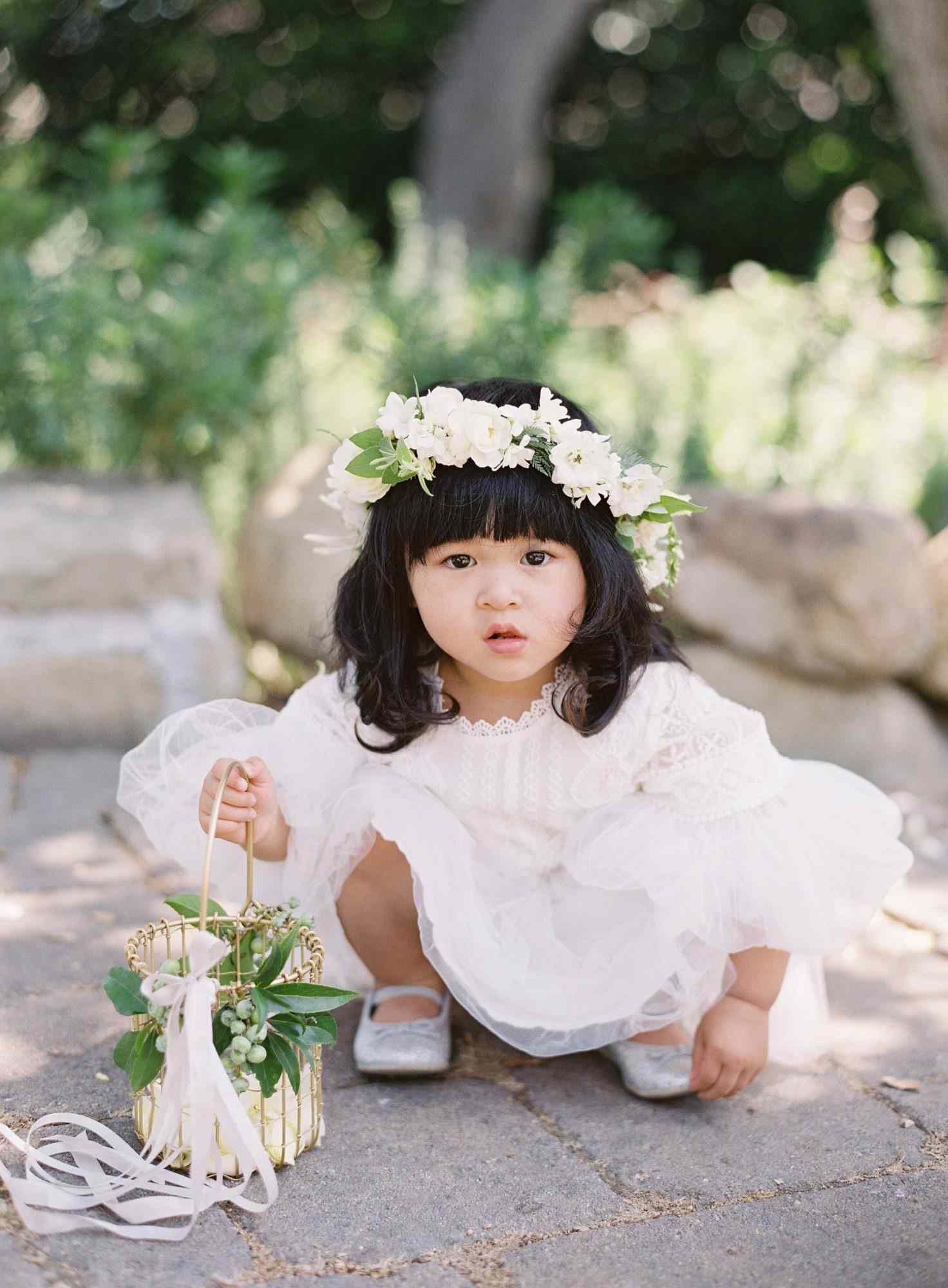 flower girl holding a gold wire basket