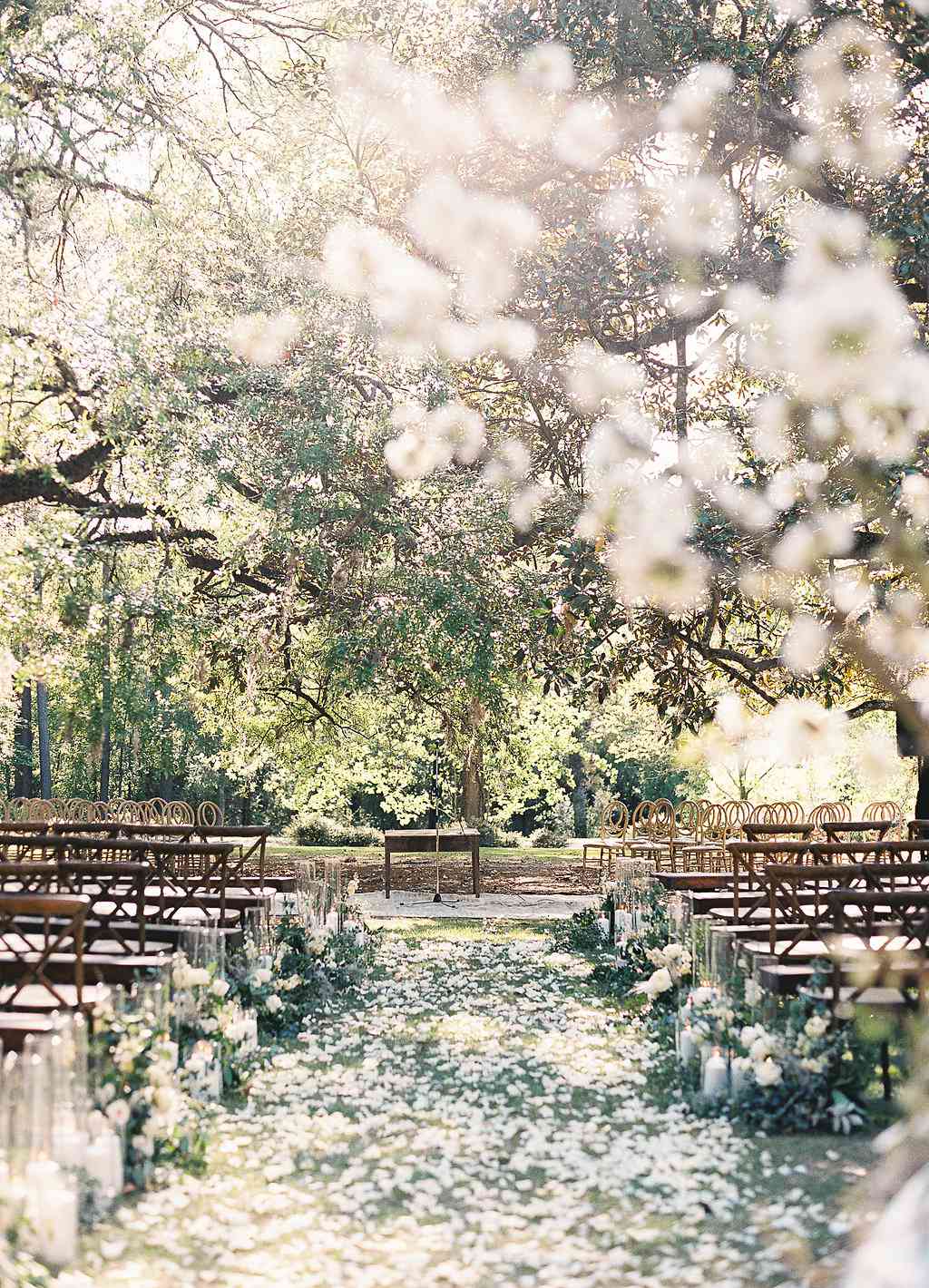 outdoor double wedding ceremony aisle lined with white flower petals