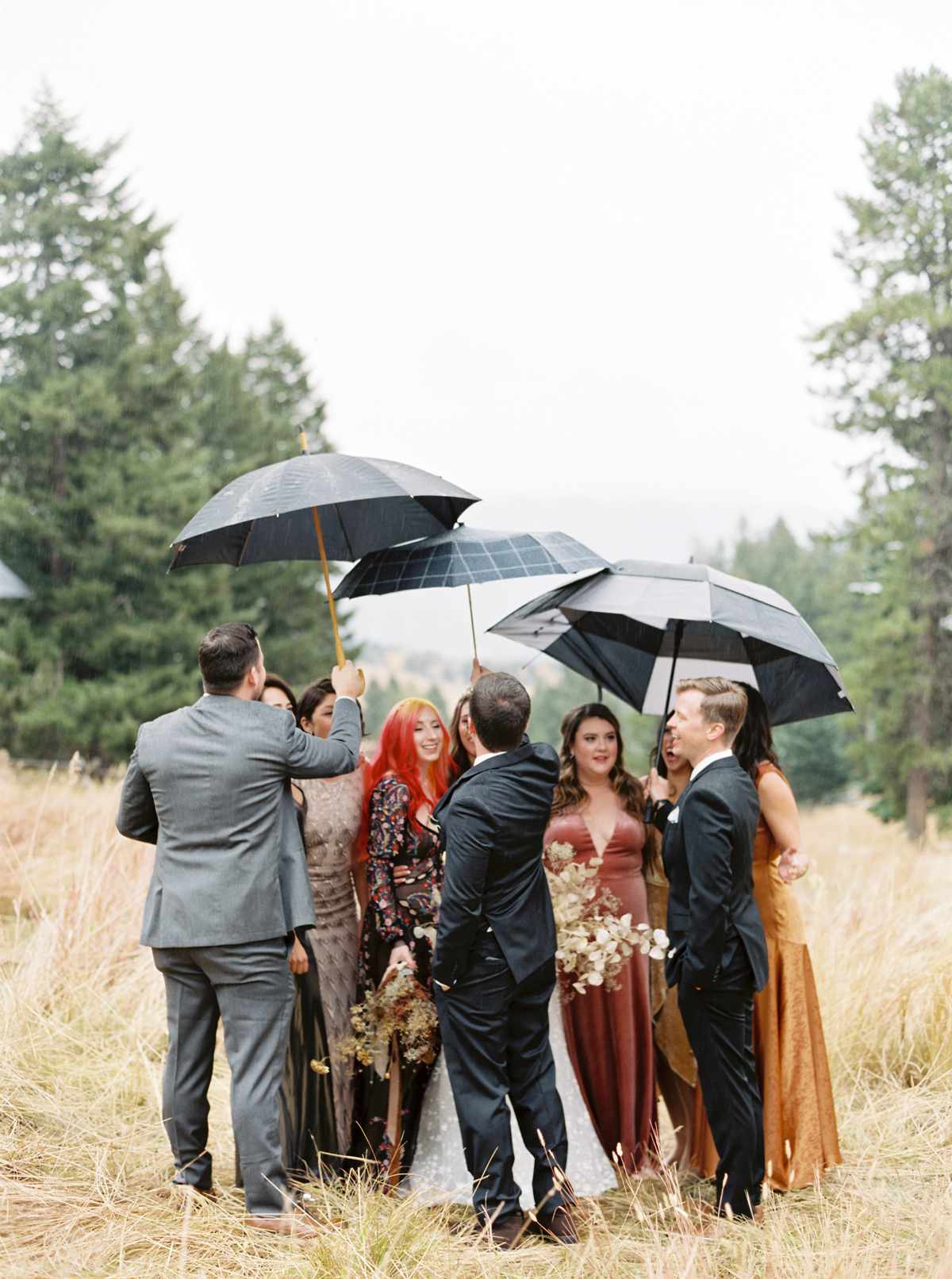 wedding party holding umbrellas