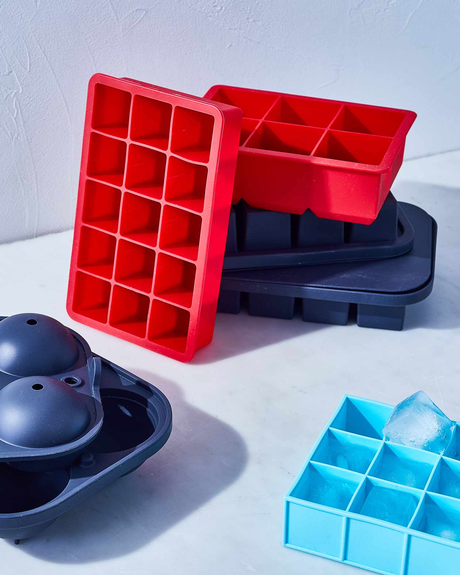 red and blue ice cube trays stacked