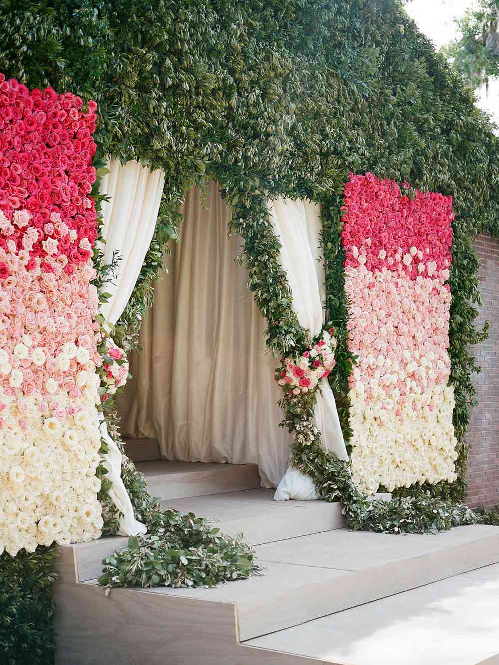wedding plant wall pink roses and greenery