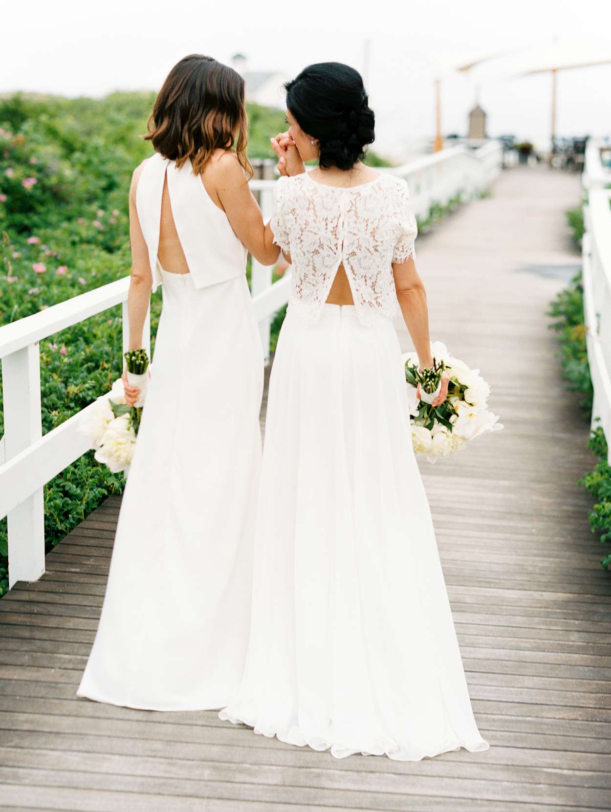 brides wearing ivory wedding dresses with split back tops