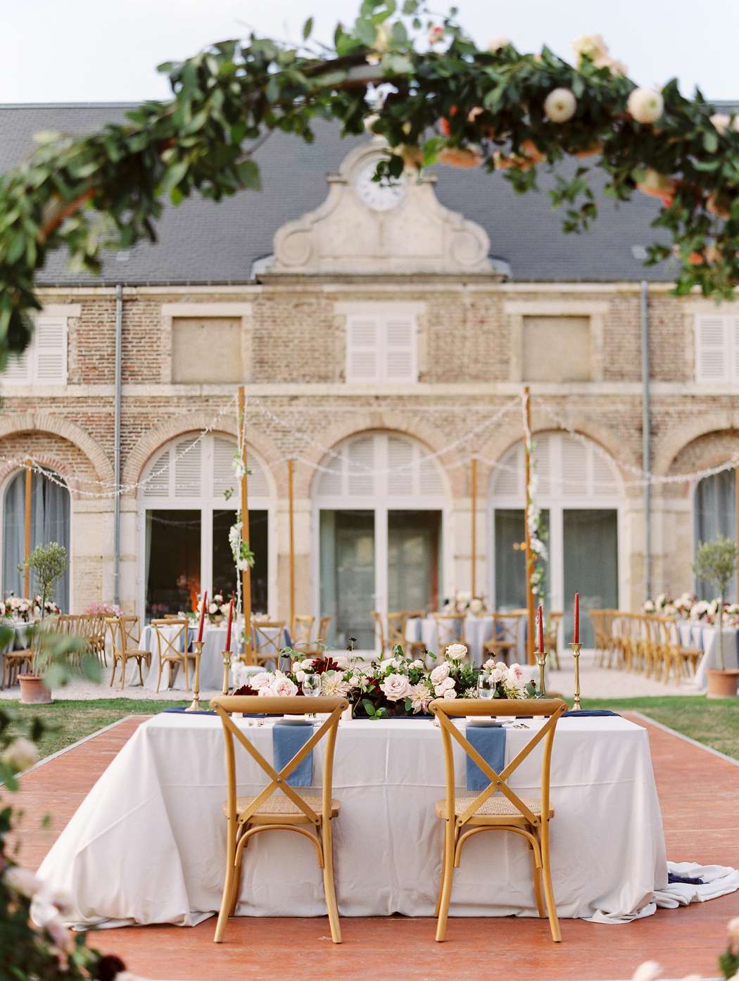 terrace wedding reception with sweetheart table and floral arch