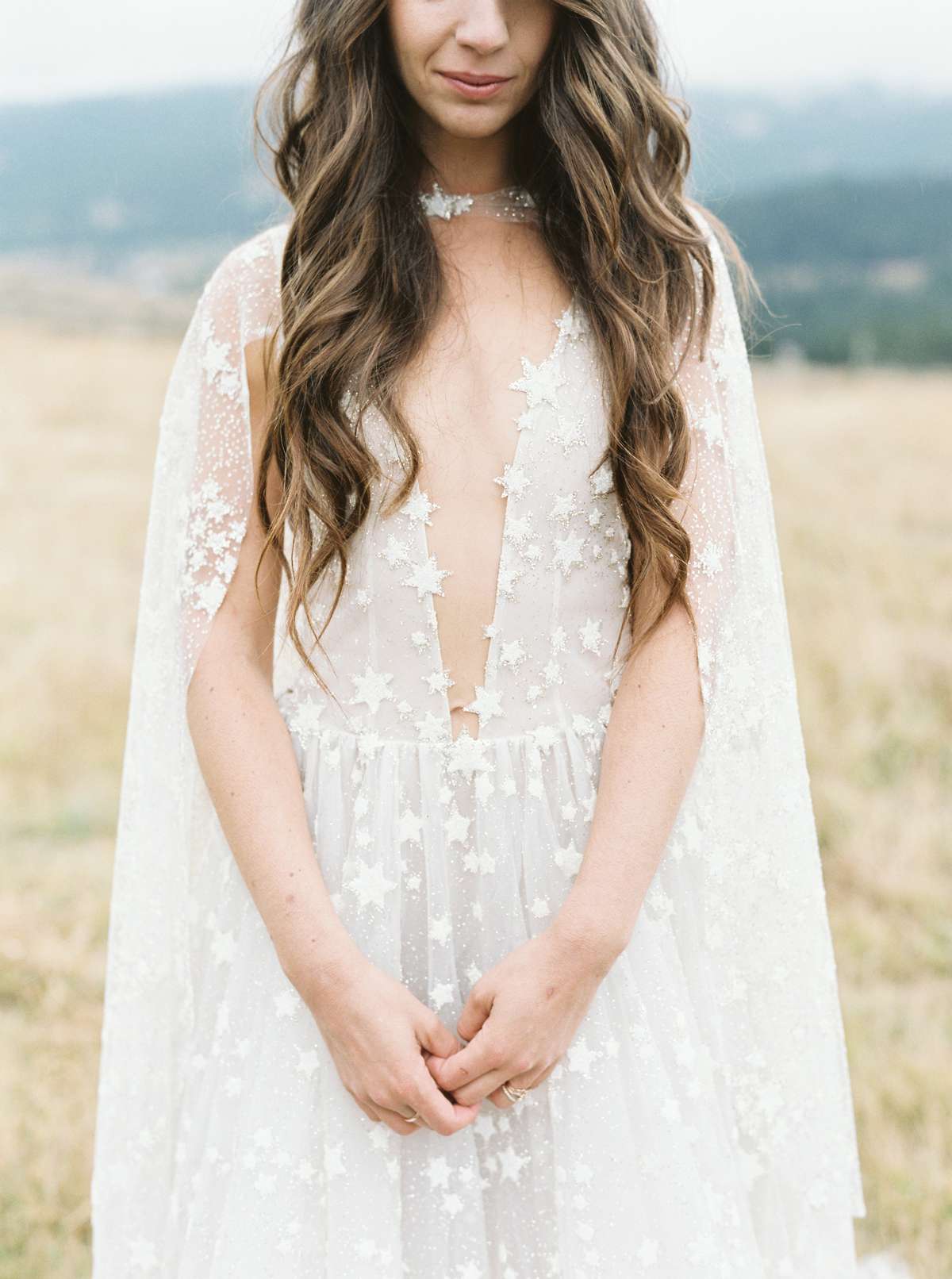bride wearing plunging neckline gown with sequined stars