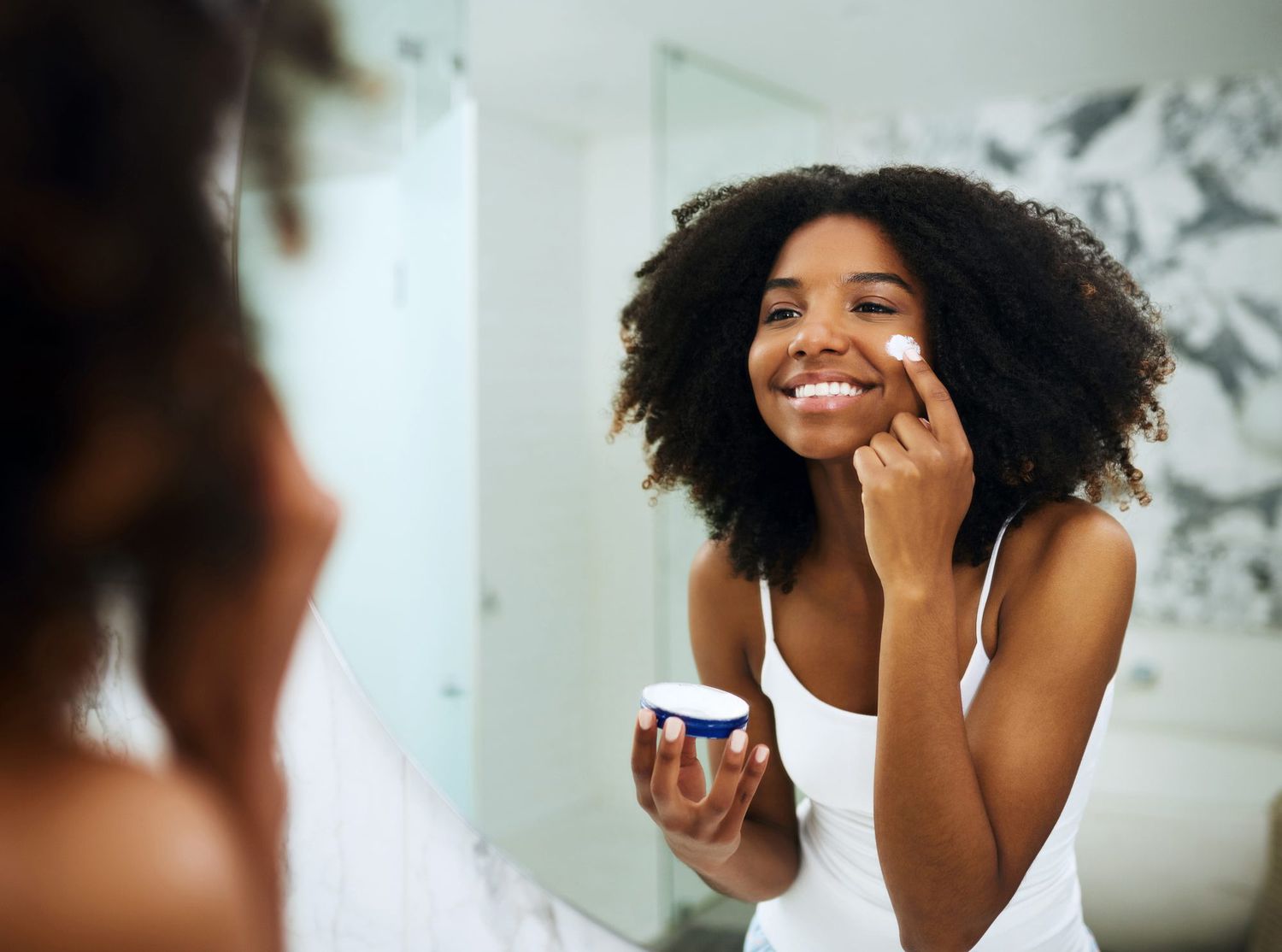 Young Woman Applying Skincare Products