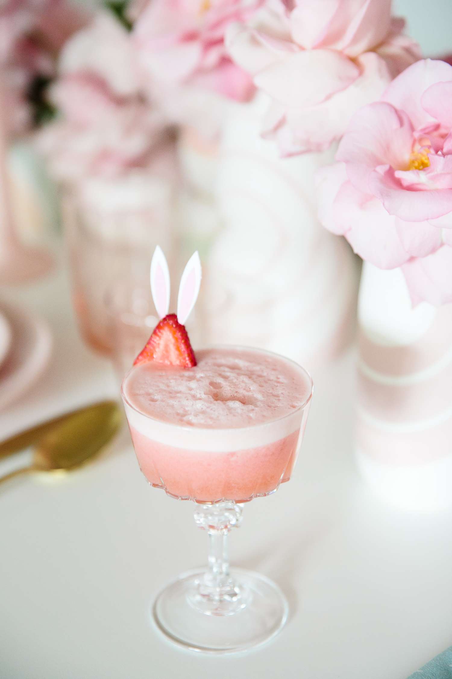 pink easter drink with strawberry bunny garnish