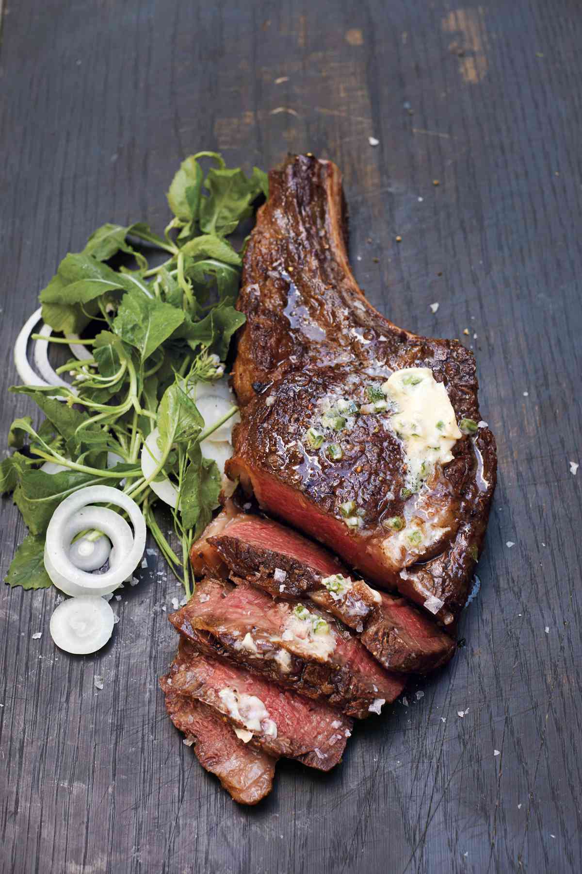 rib eye with jalapeno butter on a wooden surface
