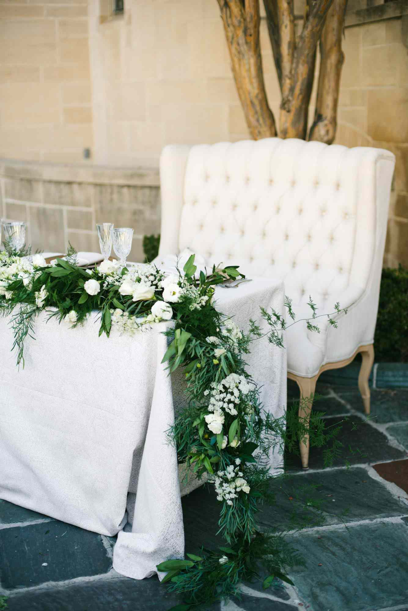 sweetheart table outdoor white chair and garland