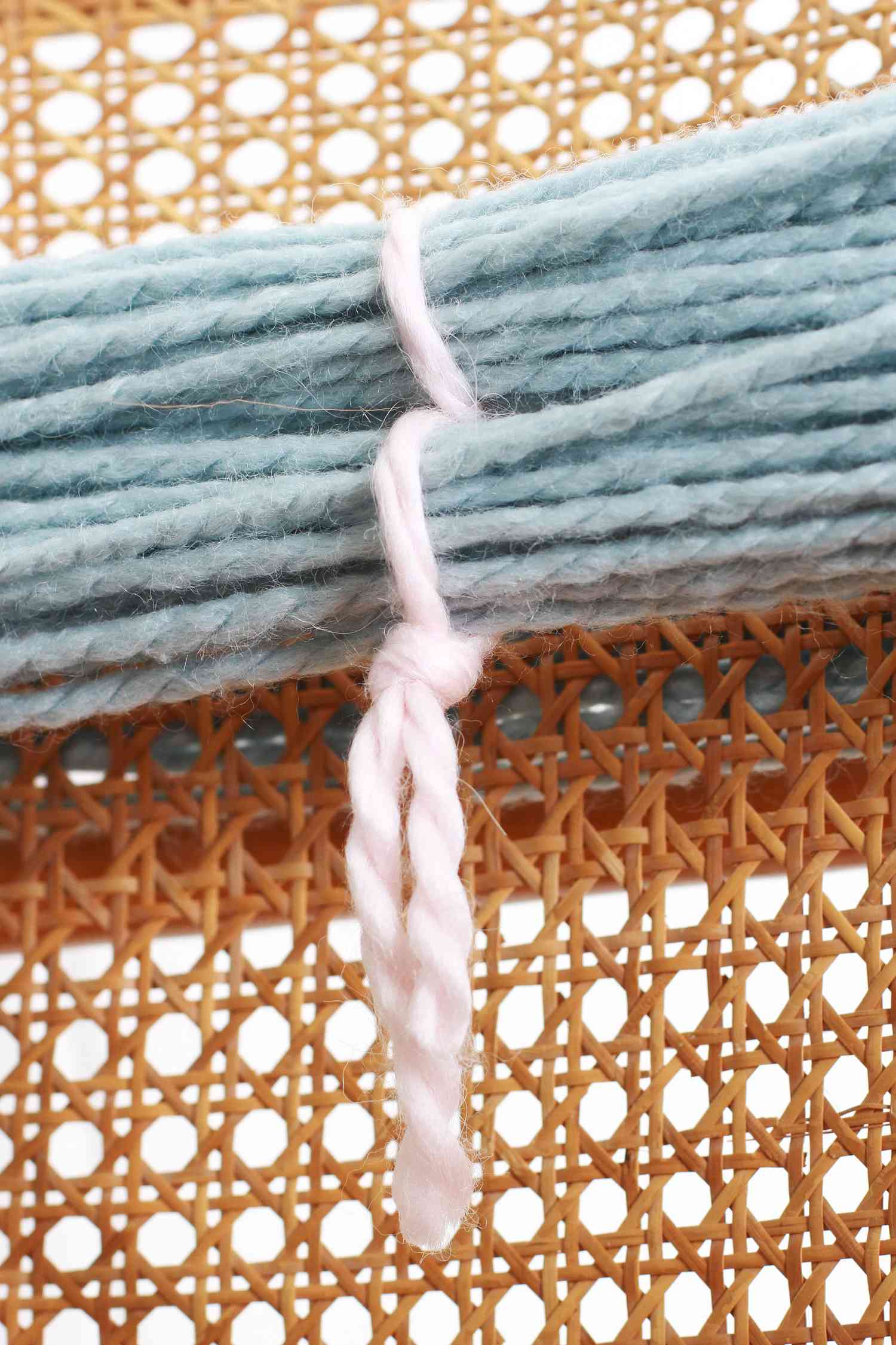 wrapped blue yarn tied with white yarn