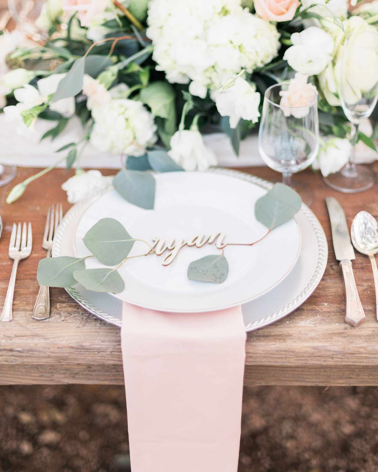 greenery to accent laser-cut place card table centerpiece