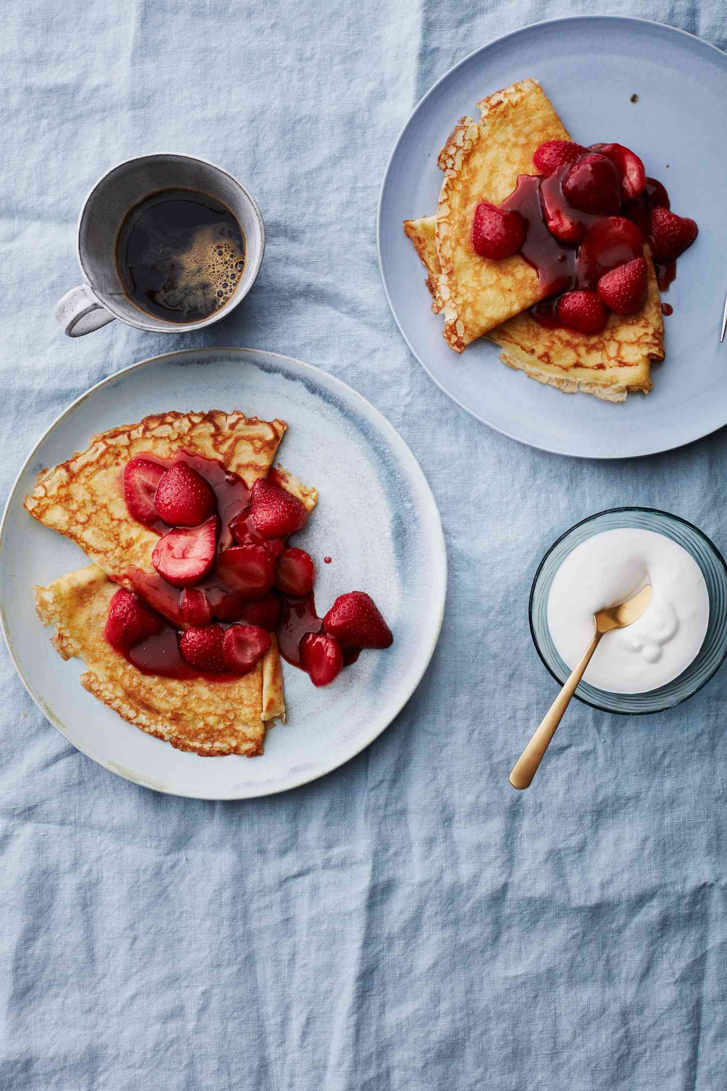 plated strawberry flambe crepes with coffee and cream