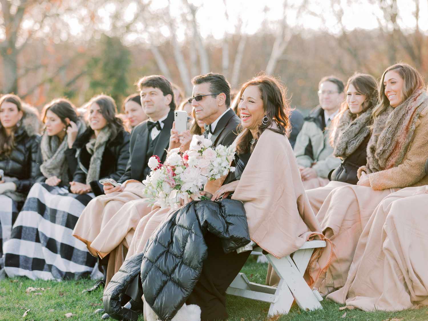 wedding guests with shawls and blankets during outdoor wedding ceremony