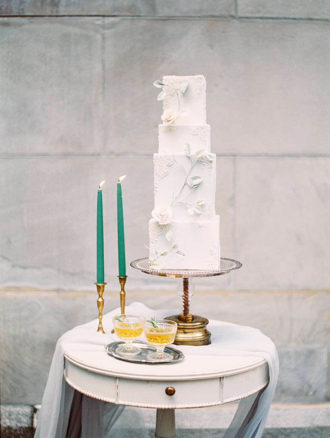 tall four tiered white bas-relief wedding cake