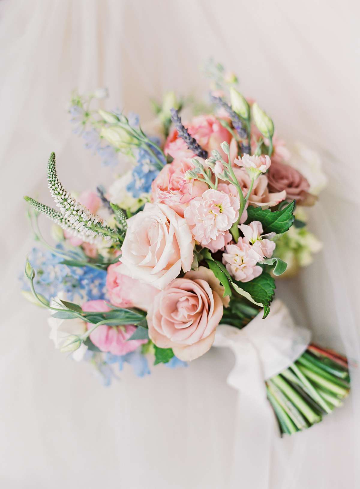 pink and blue even stem cut bouquet with white ribbon