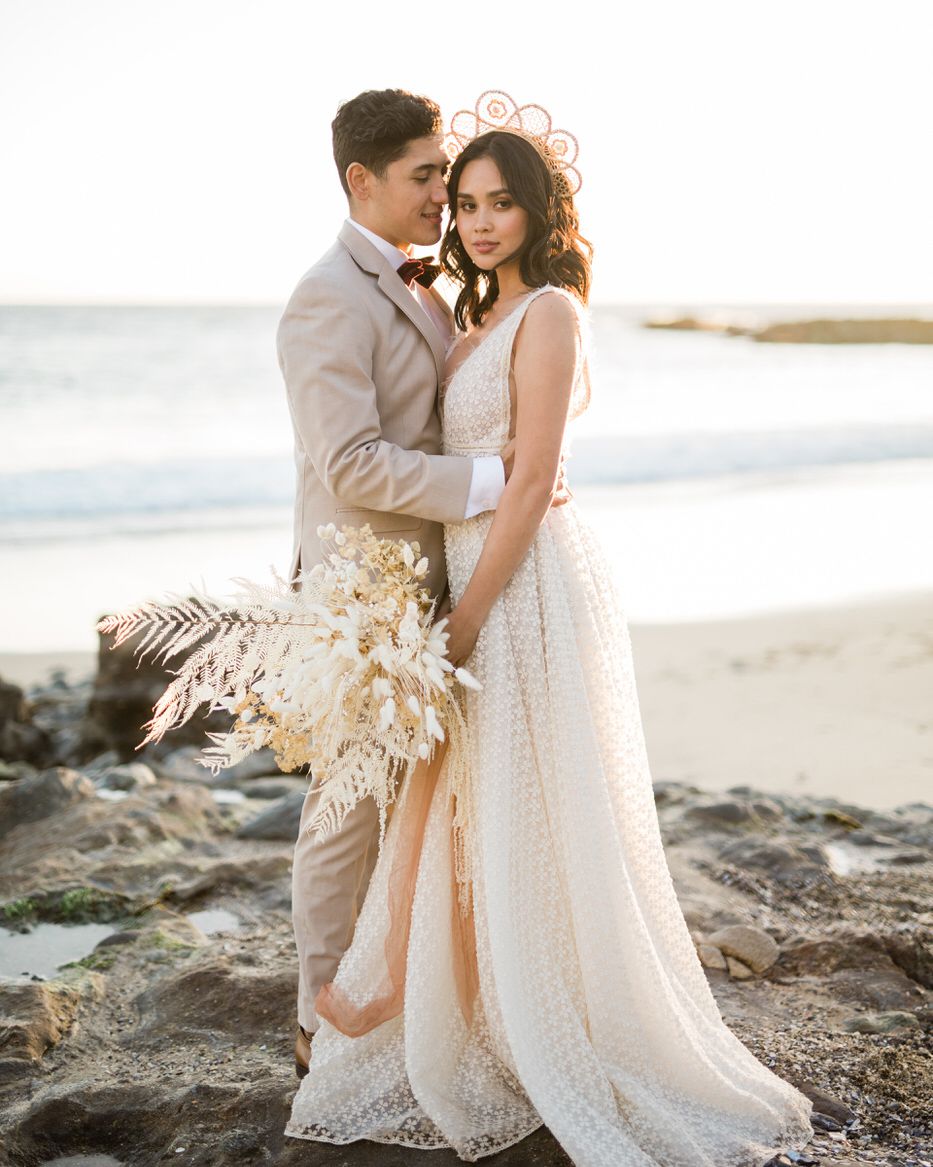 sunset wedding photos bride and groom embracing at laguna beach