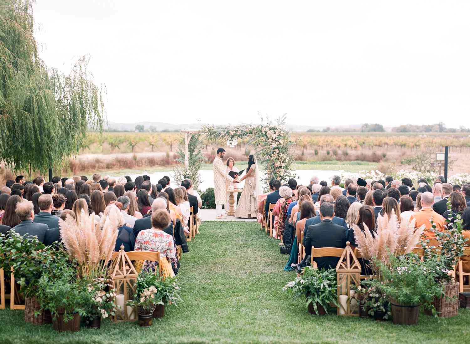 bride and groom exchange vows during outdoor wedding ceremony