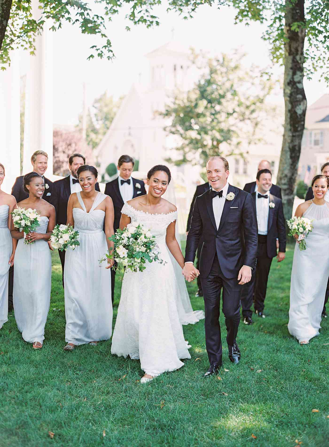 bride and groom with groomsmen wearing black tuxedos and bridesmaids wearing dove-gray chiffon gowns