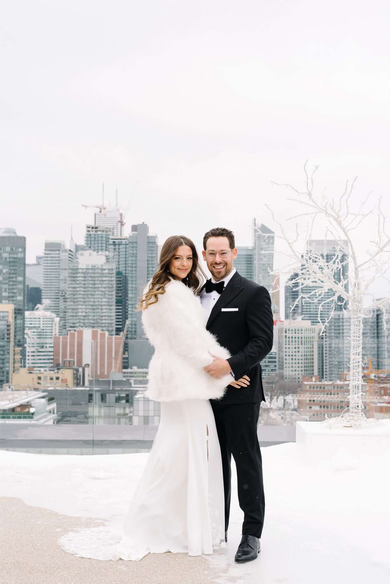 krista will wedding couple outside fur coat cityscape