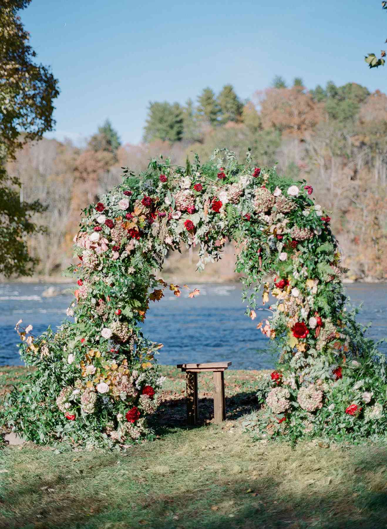 floral arch wedding ceremony backdrop next to river