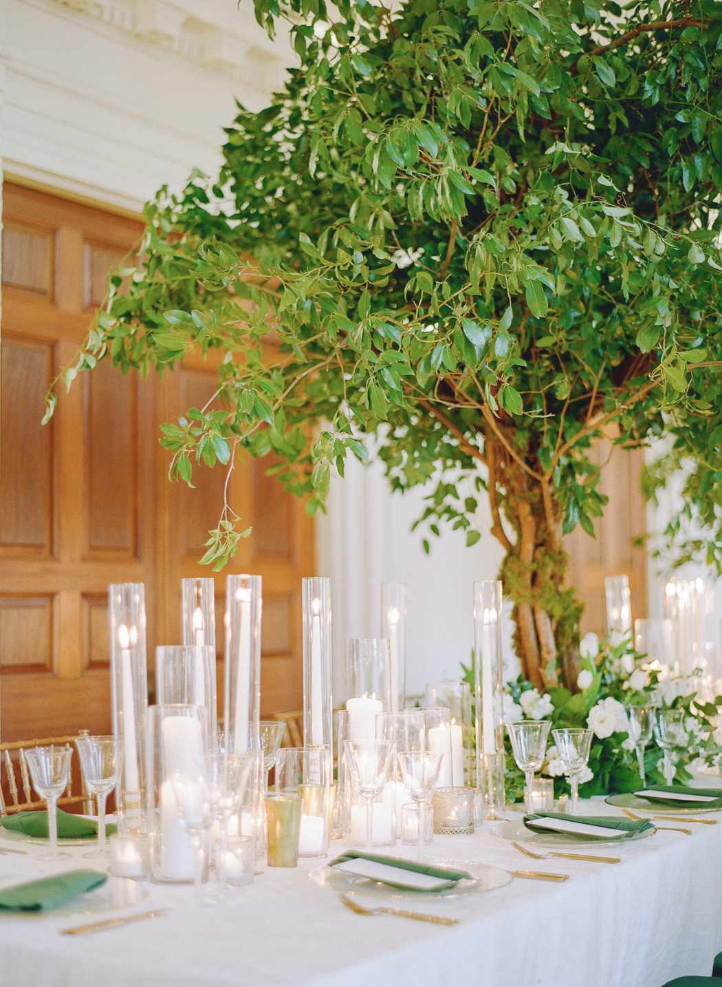 faux tree table decor with white and green reception theme