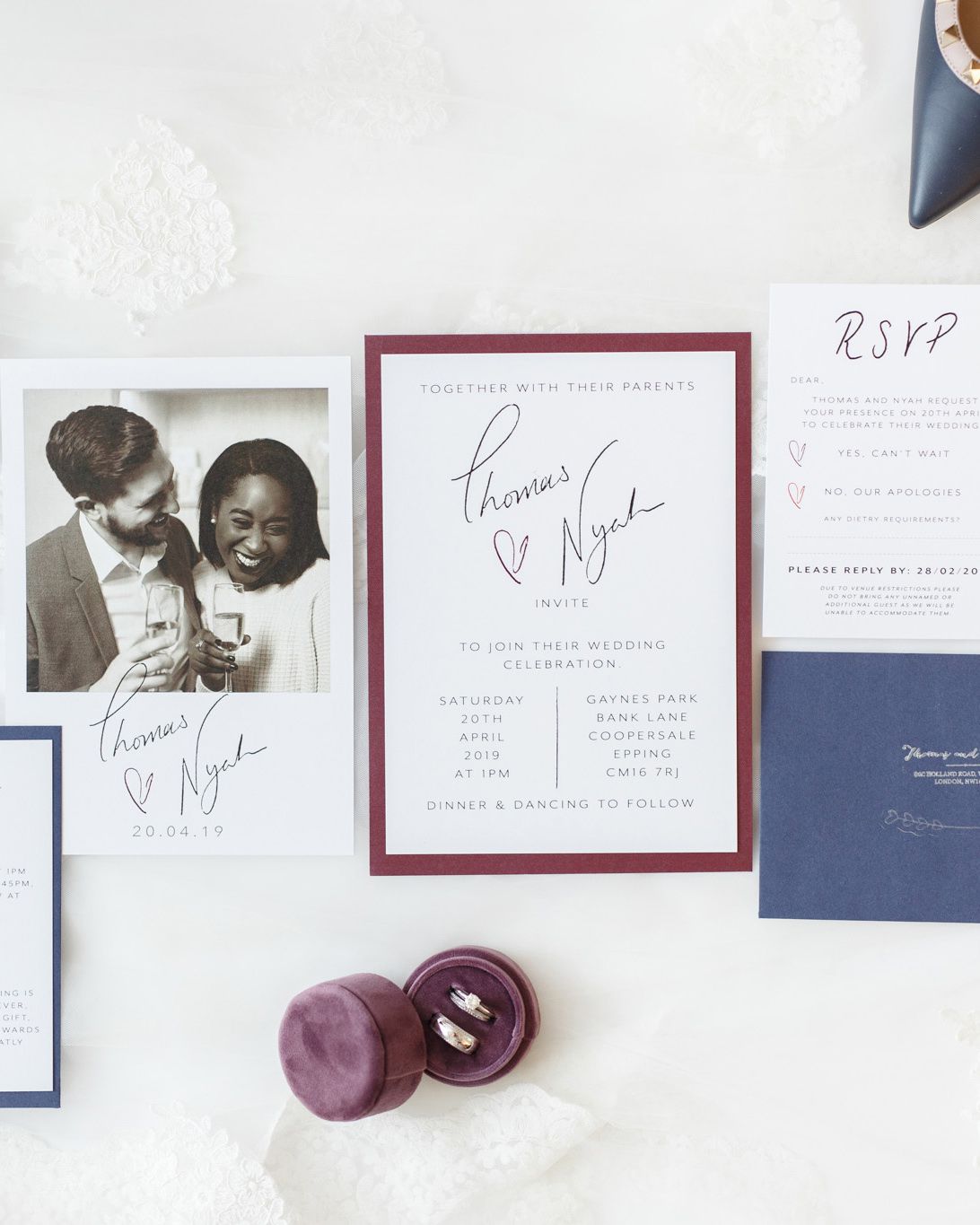 ryan thomas wedding invites in white, purple, and navy