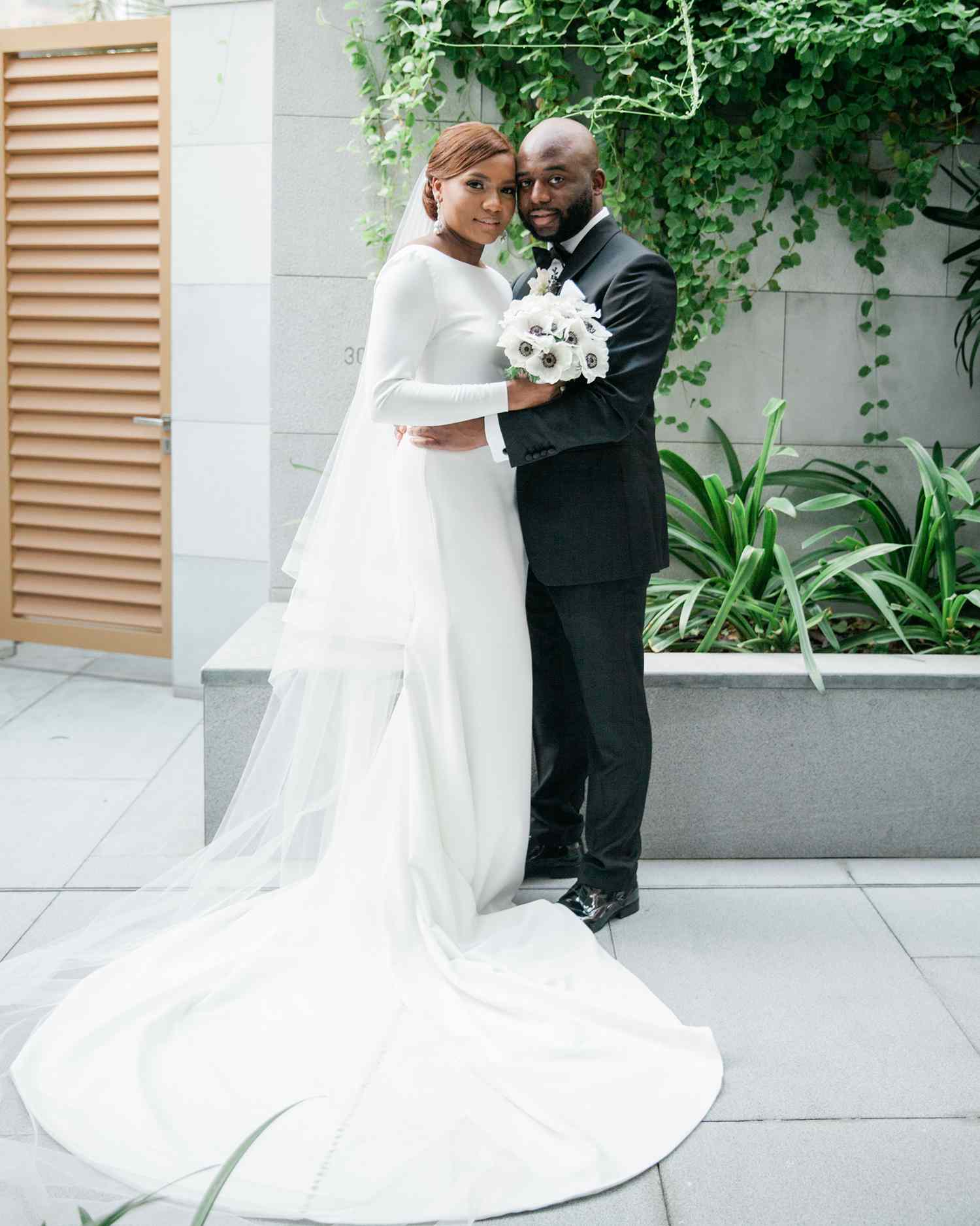 vanessa abidemi wedding couple in front of building and greenery