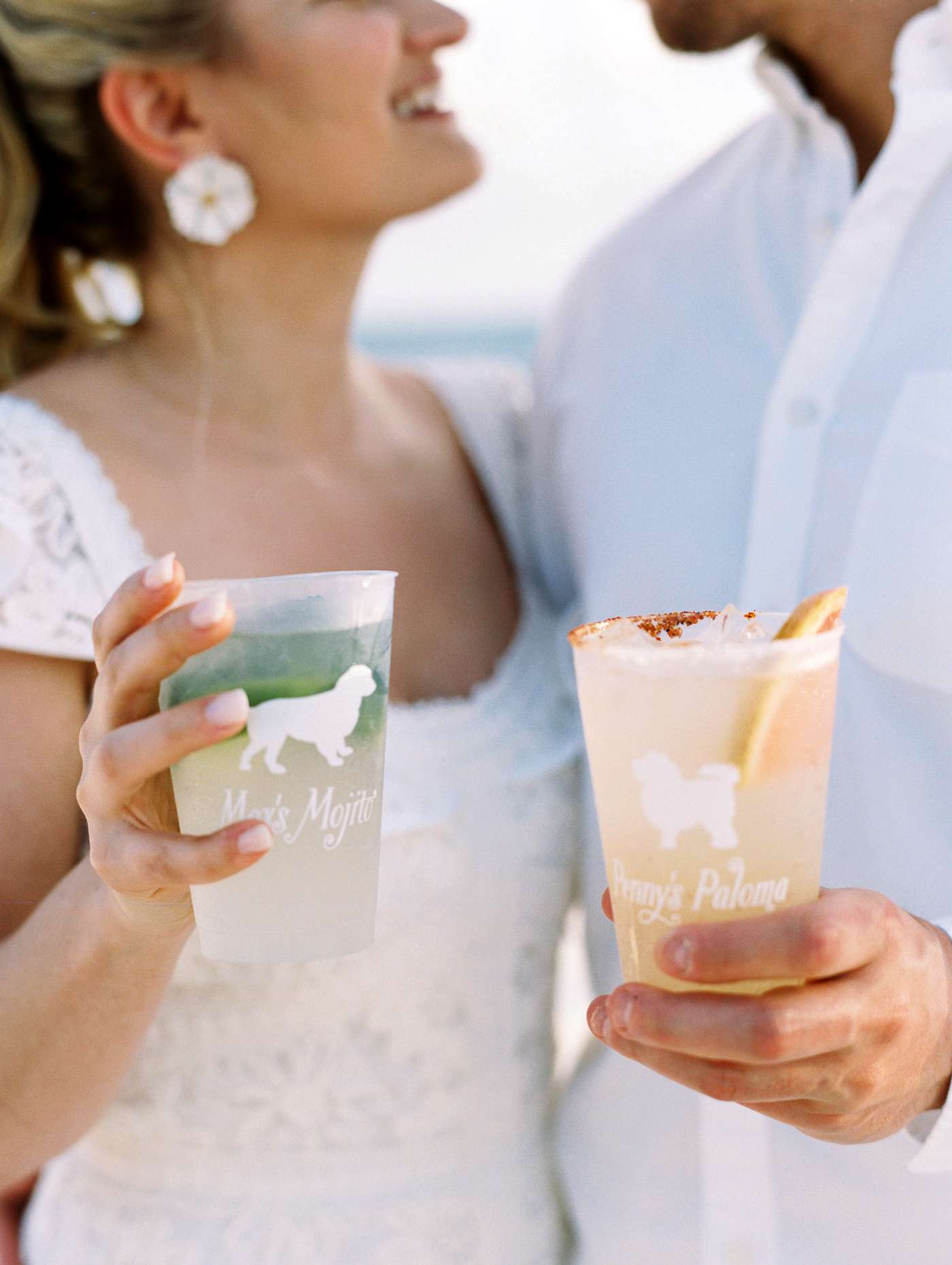 bride and groom holding palomas and mojitos signature cocktails