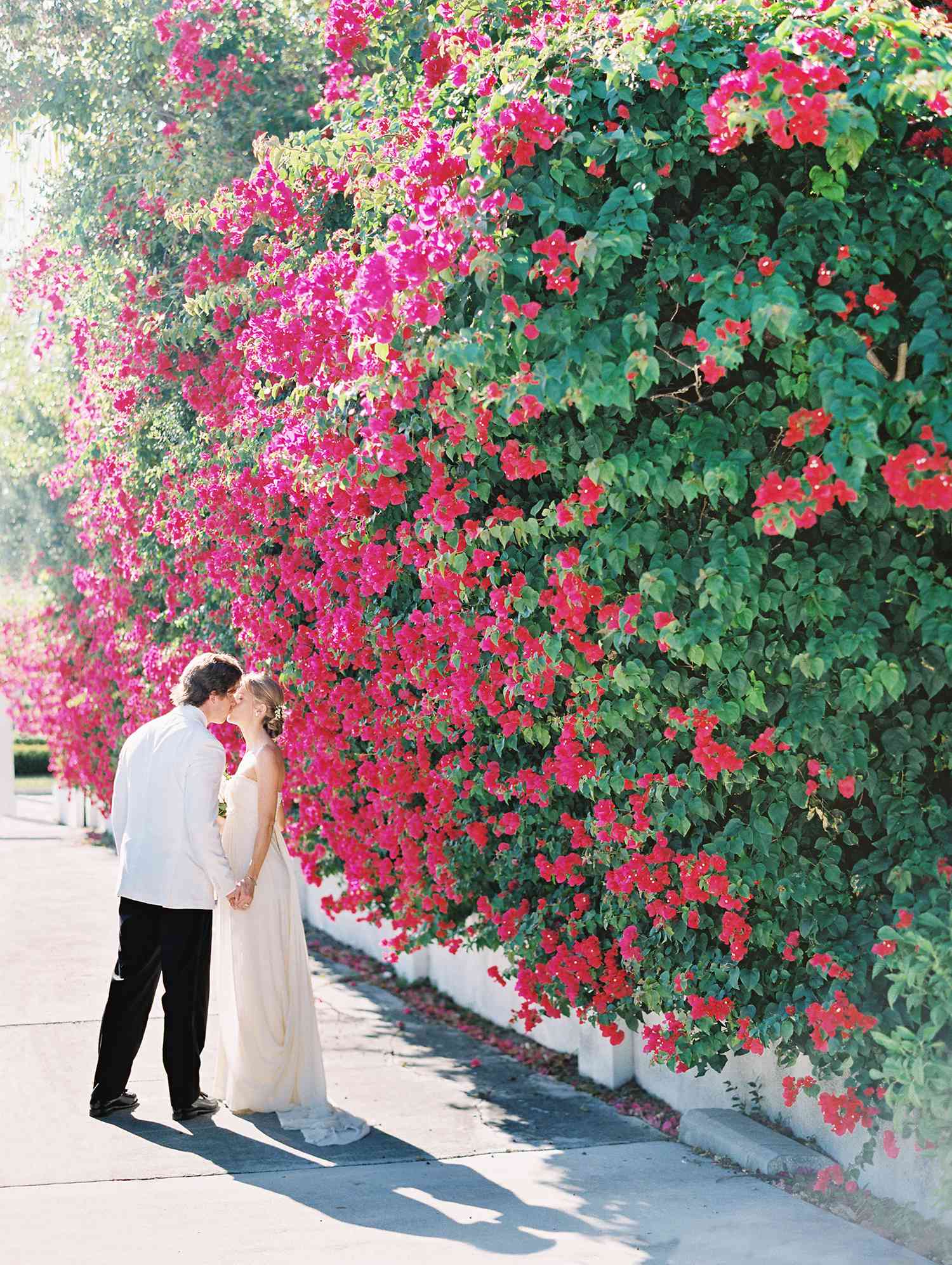 beth john couple pink flower wall kiss
