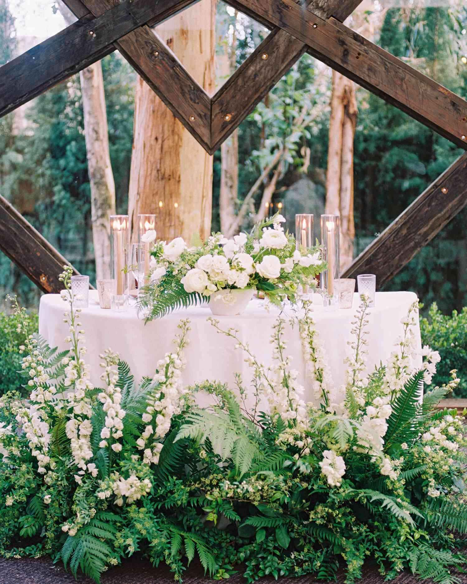 lauren aaron wedding head table surrounded by plants