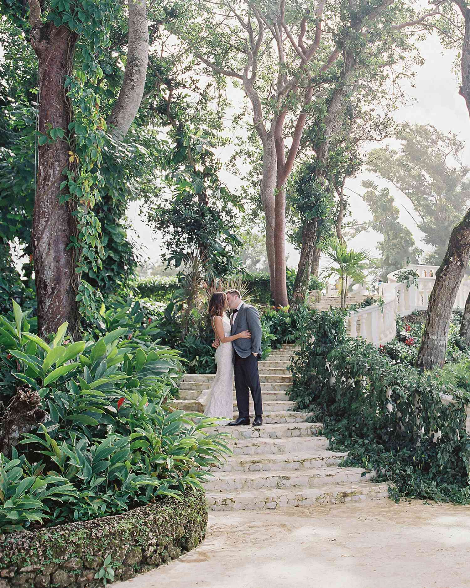 jessica ryan wedding couple kissing on stairway in lush garden