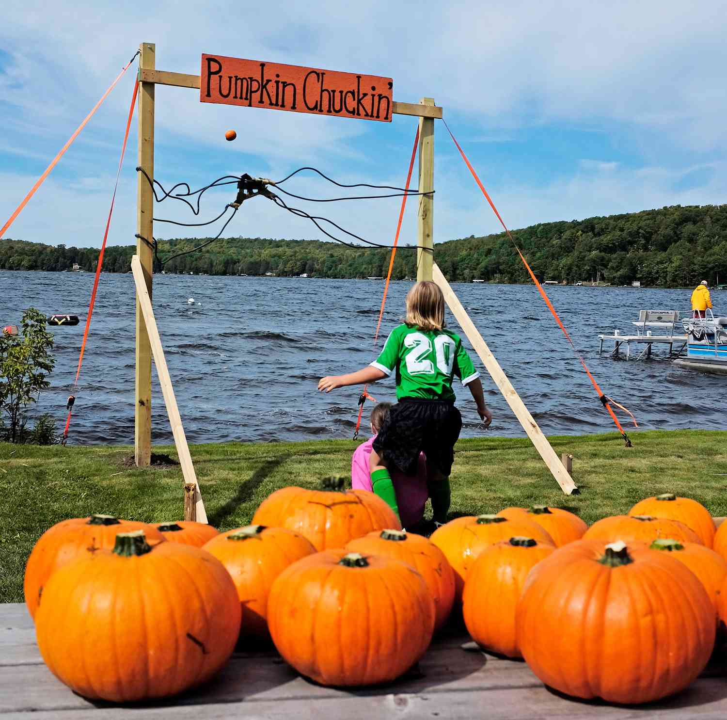 kids chucking pumpkins into lake