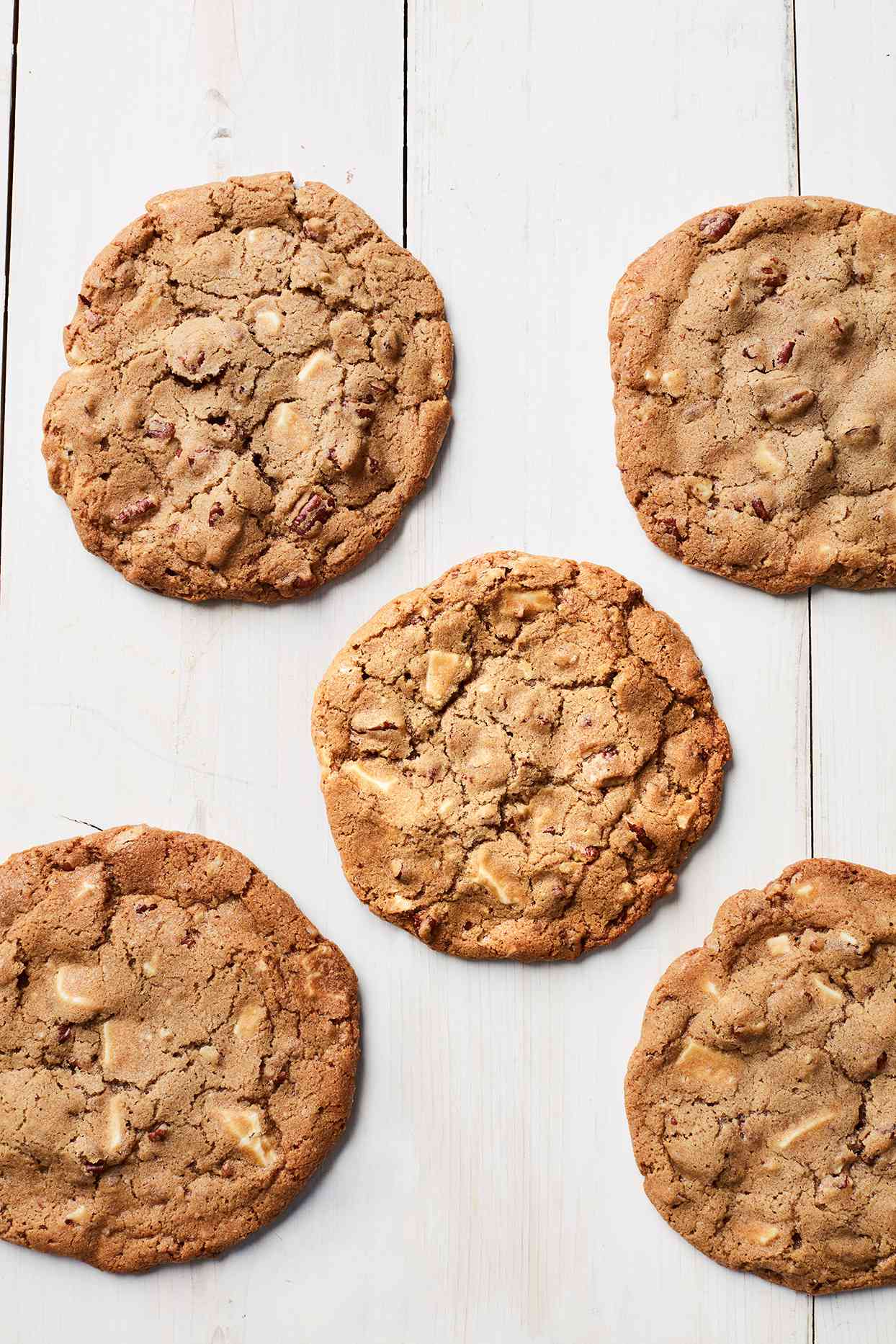 giant white-chocolate-pecan cookies against a white background