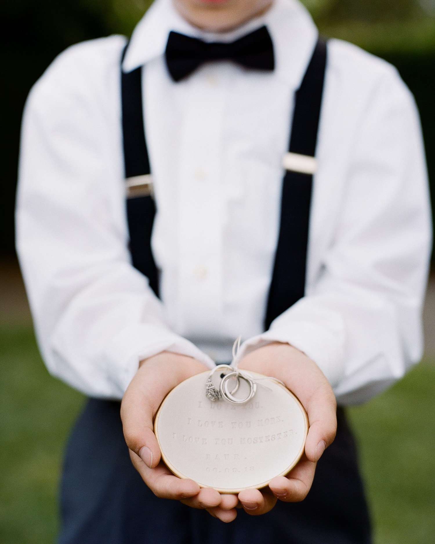 ring bearer holding decorative dish at wedding