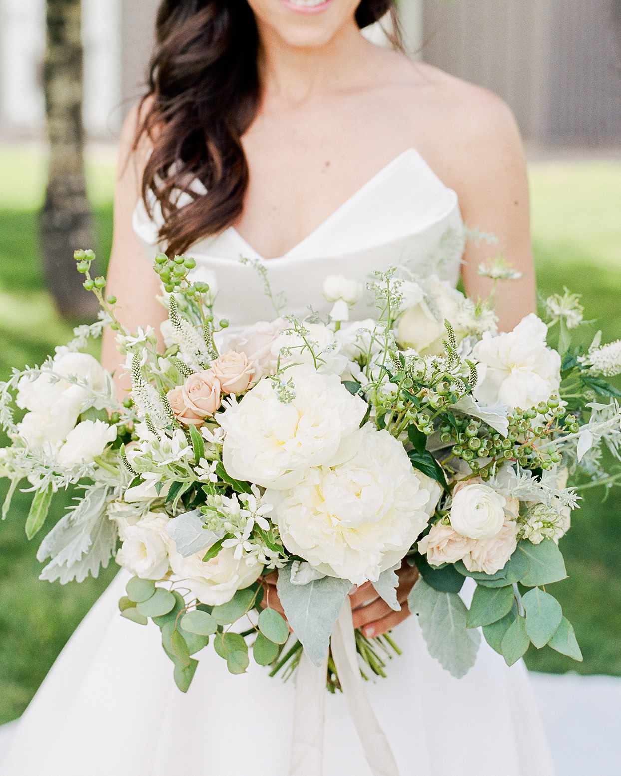 jessica aaron bride holding white wedding bouquet